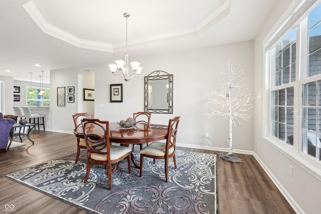 9359 Foudray Cir N, Avon, IN 46123 - dining room with dark wood finished floors, a raised ceiling, baseboards, a chandelier, and crown molding
