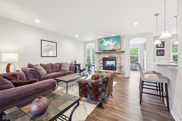 9359 Foudray Cir N, Avon, IN 46123 - living room featuring arched walkways, healthy amount of natural light, wood finished floors, recessed lighting, and a fireplace