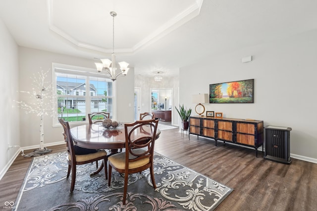 9359 Foudray Cir N, Avon, IN 46123 - dining area featuring dark wood-type flooring, a raised ceiling, a chandelier, baseboards, and ornamental molding