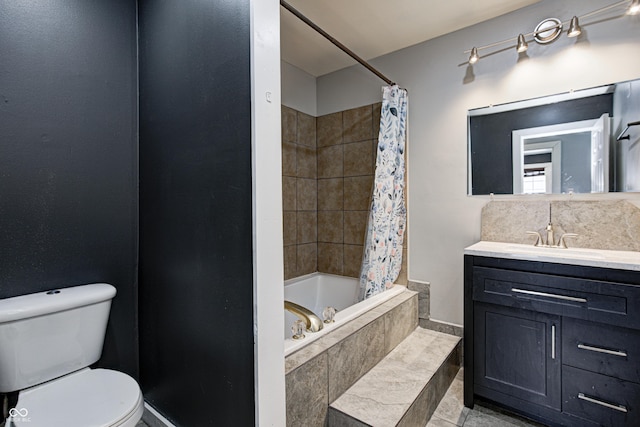 bathroom featuring vanity, tile patterned floors, tiled shower / bath combo, and toilet