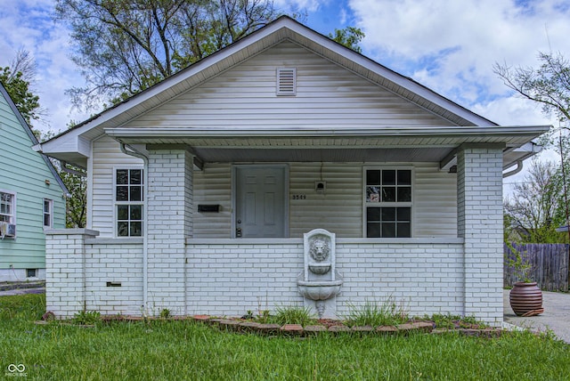 view of front of house featuring a porch and brick siding
