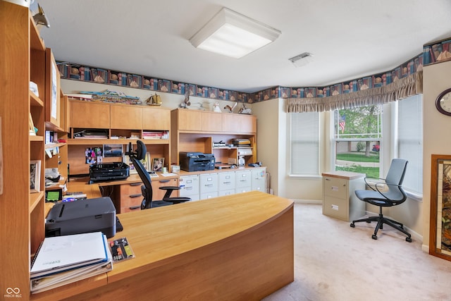 office area with baseboards, visible vents, and light carpet