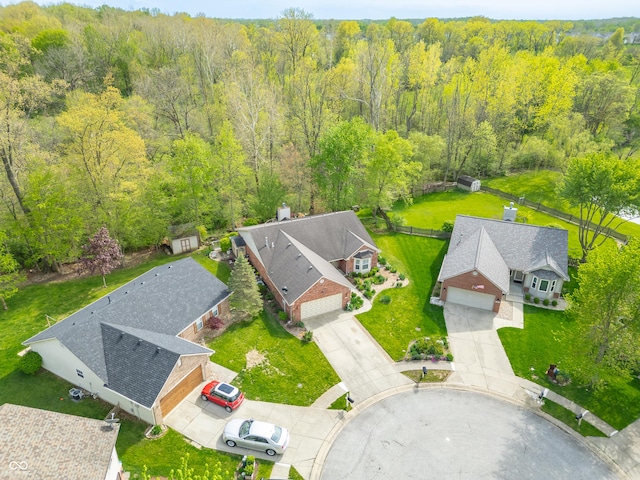 birds eye view of property featuring a view of trees