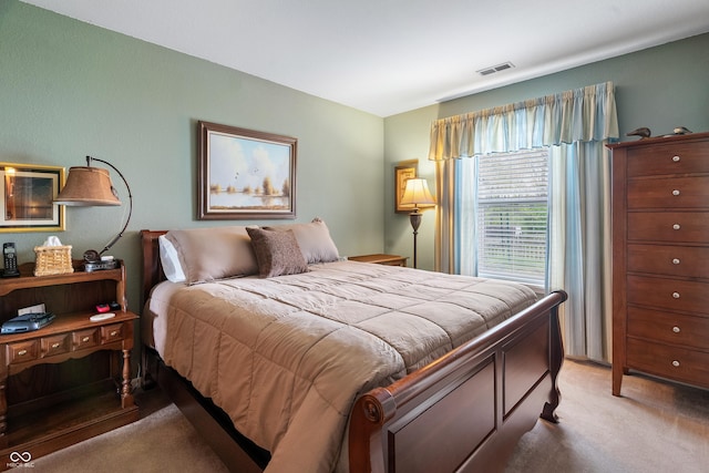 bedroom with light carpet and visible vents