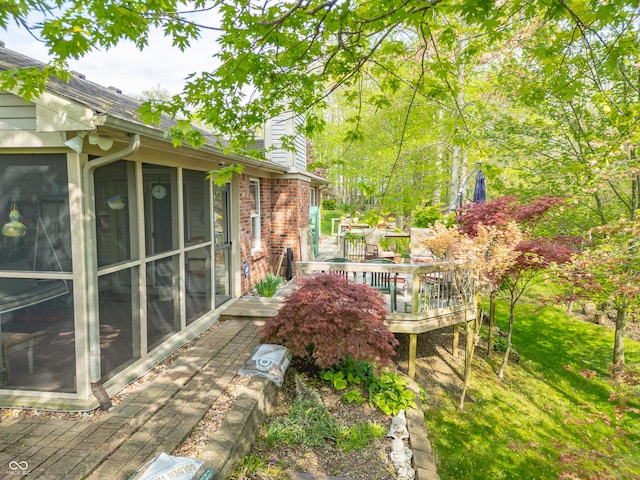 view of yard with a sunroom and a deck