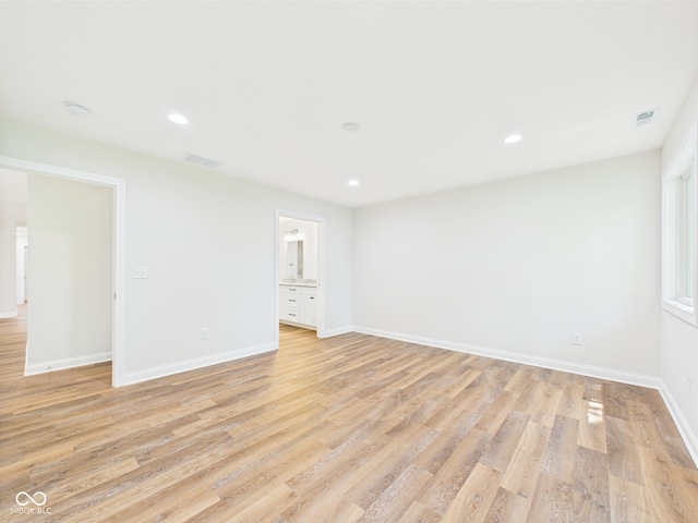 spare room featuring recessed lighting, baseboards, light wood finished floors, and visible vents