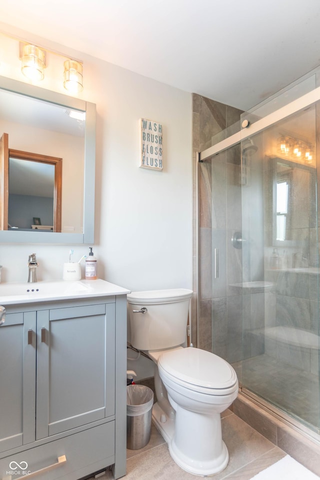 full bath with toilet, a stall shower, and vanity