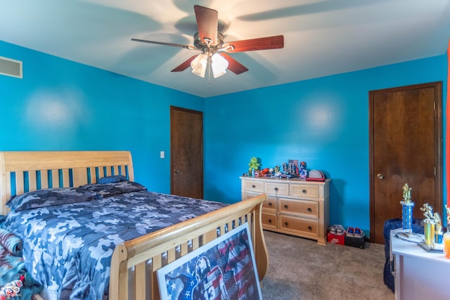 carpeted bedroom with a ceiling fan and visible vents