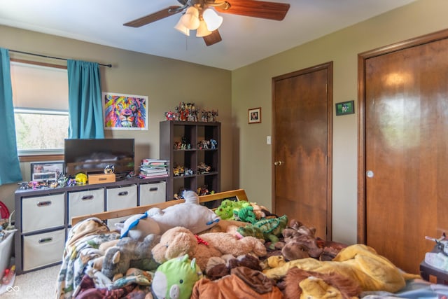 carpeted bedroom featuring a ceiling fan