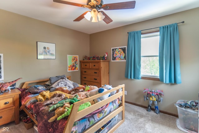 carpeted bedroom featuring a ceiling fan and baseboards