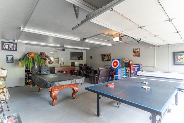 rec room with a garage, concrete flooring, and pool table