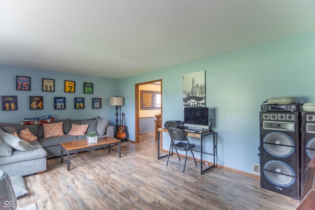 living area featuring baseboards and wood finished floors