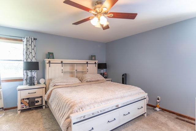 bedroom featuring light colored carpet, baseboards, ceiling fan, and visible vents