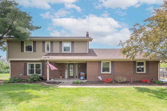 traditional home featuring a chimney, a front lawn, and brick siding
