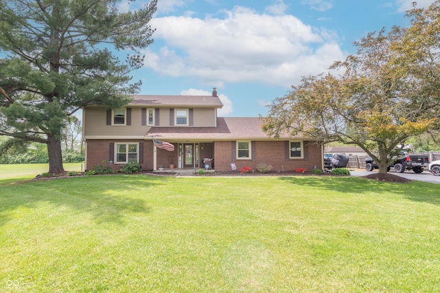 traditional-style home featuring a porch, brick siding, a chimney, and a front lawn