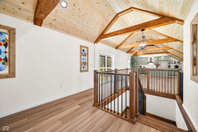 bonus room with wood ceiling, wood finished floors, baseboards, lofted ceiling with beams, and a notable chandelier