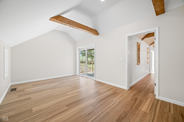 interior space with baseboards, visible vents, light wood-style flooring, and lofted ceiling