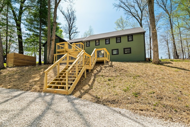 exterior space with a wooden deck and stairway