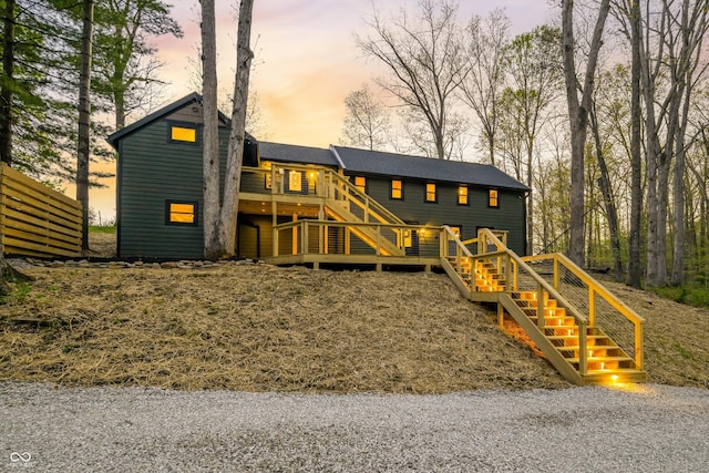 view of front of home with stairway and a deck