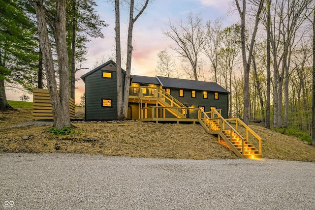 view of front of house featuring stairs and a deck