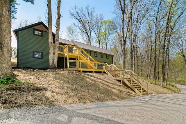 view of front facade featuring stairs and a deck