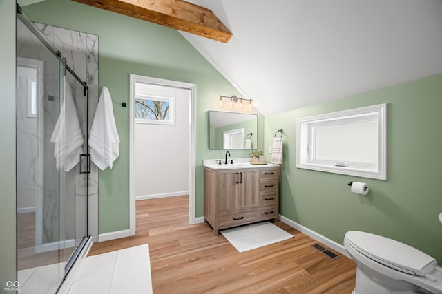 bathroom featuring vaulted ceiling with beams, a marble finish shower, and wood finished floors