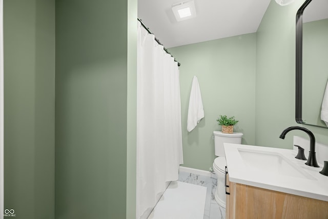 bathroom featuring vanity, marble finish floor, baseboards, and toilet