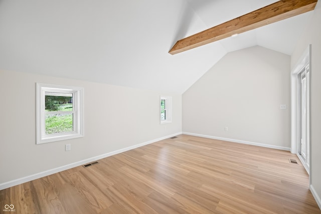additional living space with lofted ceiling with beams, light wood finished floors, and visible vents
