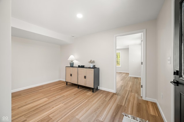 interior space with baseboards and light wood finished floors