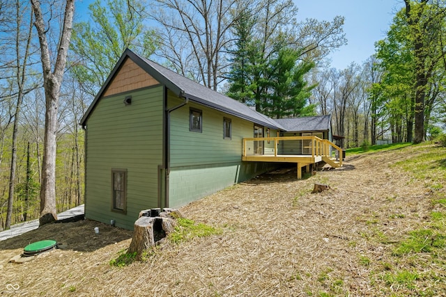 view of property exterior featuring stairs and a deck