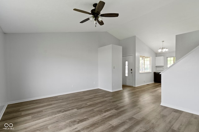 6638 Sunbury Dr, Indianapolis, IN 46241 - unfurnished living room with baseboards, ceiling fan with notable chandelier, dark wood-style flooring, and high vaulted ceiling