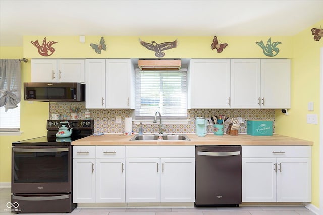 kitchen featuring white cabinets, a sink, electric range oven, tasteful backsplash, and stainless steel dishwasher