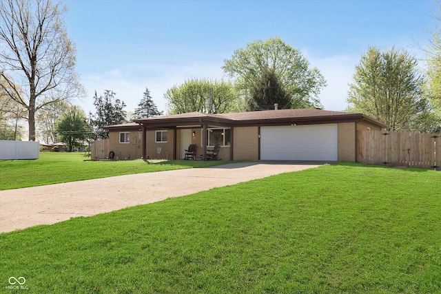 single story home with an attached garage, a front lawn, fence, and concrete driveway