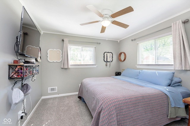 bedroom with crown molding, baseboards, multiple windows, and carpet flooring