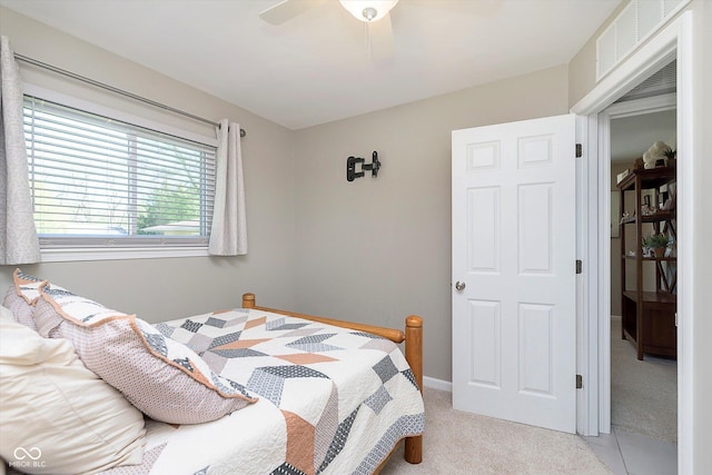 bedroom with light carpet, a ceiling fan, and visible vents