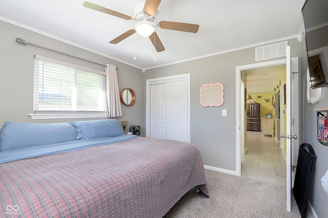 bedroom featuring visible vents, light tile patterned floors, a closet, stainless steel fridge, and ornamental molding