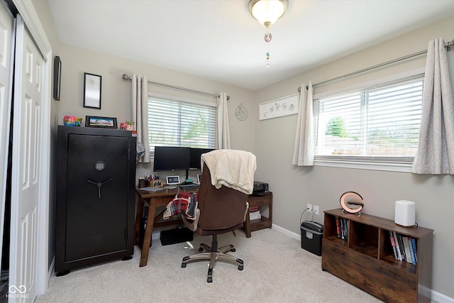 carpeted home office featuring baseboards