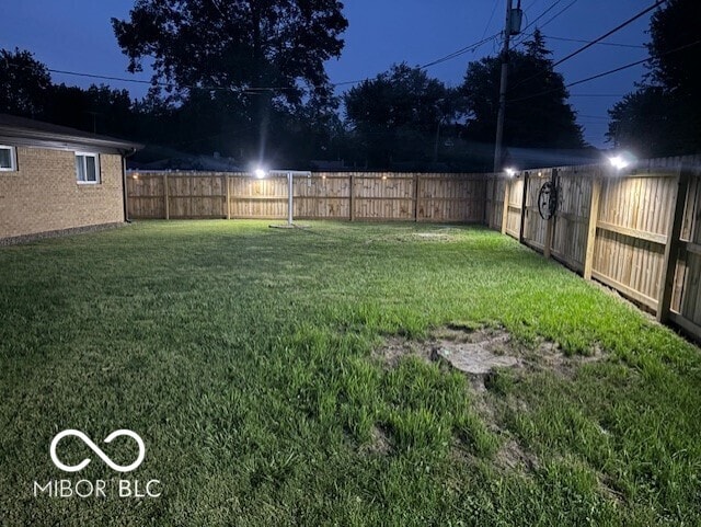 view of yard with a fenced backyard