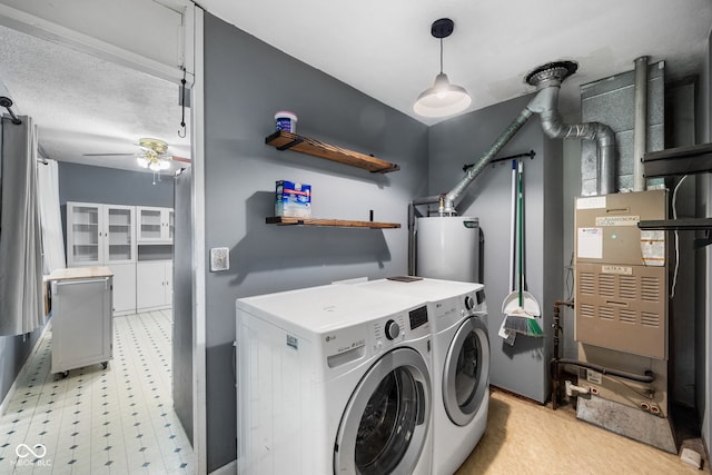 laundry area featuring a ceiling fan, light floors, washer and clothes dryer, laundry area, and water heater