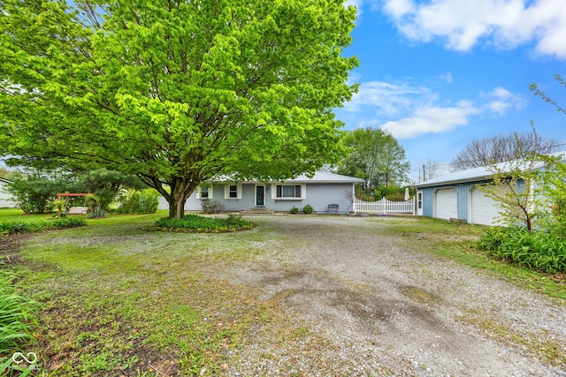 view of front of house featuring fence and a garage