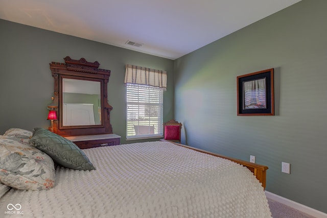 carpeted bedroom featuring visible vents and baseboards