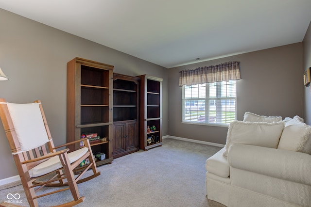 carpeted living room featuring baseboards