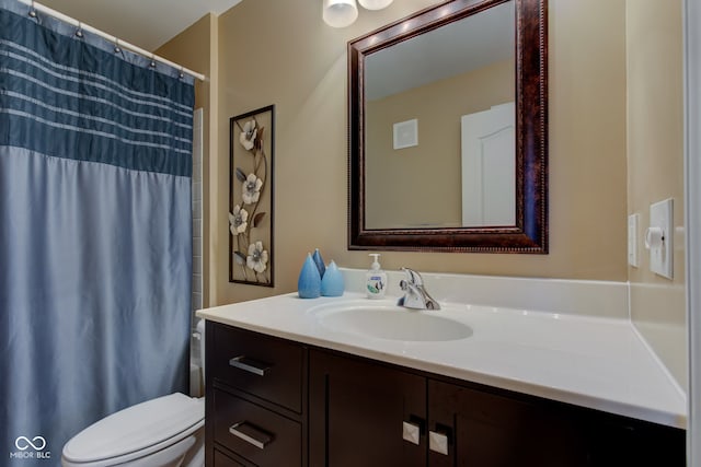 bathroom with vanity, curtained shower, and toilet