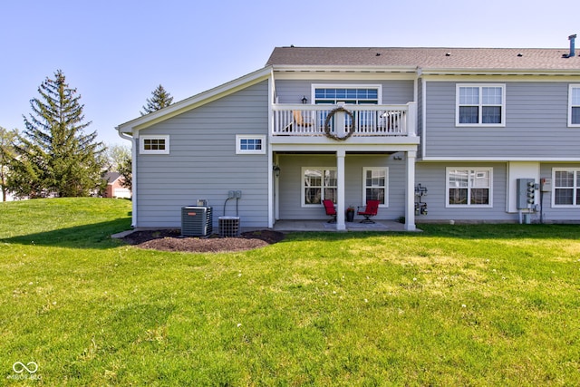 back of house with a yard, central AC, a balcony, and a patio area