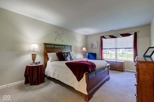 carpeted bedroom with baseboards and visible vents