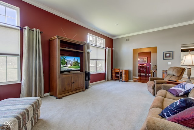 living room featuring baseboards, visible vents, ornamental molding, and carpet