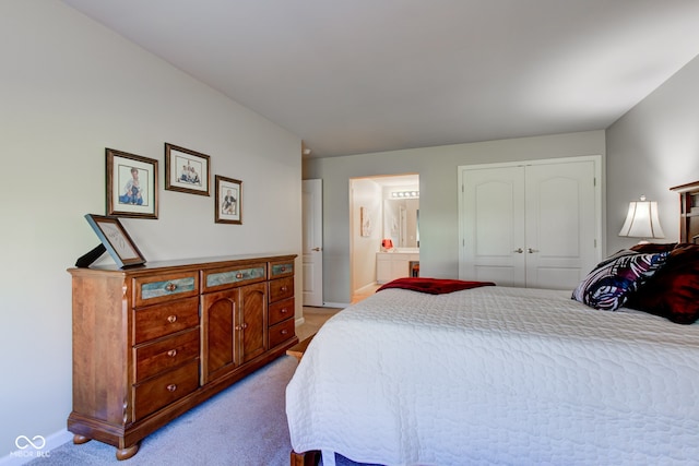 carpeted bedroom with baseboards, connected bathroom, and a closet