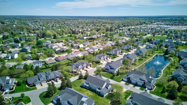 birds eye view of property with a water view and a residential view