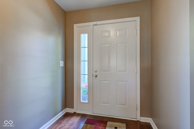 entryway with baseboards and dark wood finished floors
