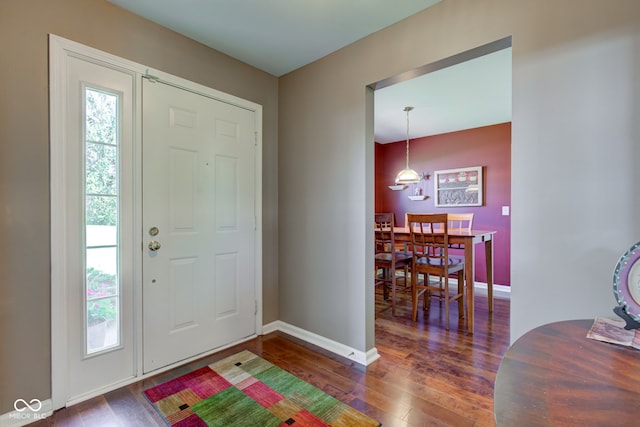entryway featuring baseboards and hardwood / wood-style floors